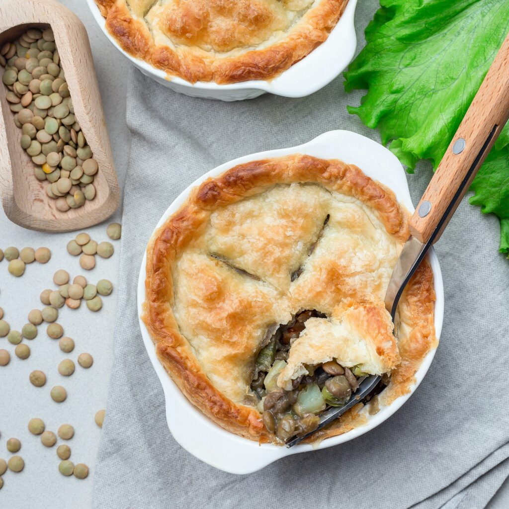 Vegetarian pot pie with lentil, mushrooms, potato, carrot and gr